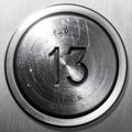 Worn Metal Button for the Thirteenth Floor Royalty Free Stock Photo