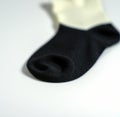 Close up of black and white sock on white background