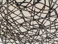 Close-up of black wires woven in abstract overlapping pattern. Royalty Free Stock Photo