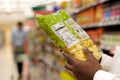 Close up of black woman reading food label in supermarket