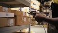 Close up of black worker using a barcode scanner to process shipping labels Royalty Free Stock Photo