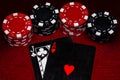 A close up of Blackjack hand with unique black, white and red cards with Black and Red Clay poker chips on a Dark Red Felt table Royalty Free Stock Photo