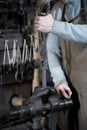 Close-up of a blacksmith hand working in a smithy with his tools Royalty Free Stock Photo