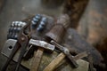 Close-up of a blacksmith`s hands manipulating a metal piece above his forge, selective focus. Royalty Free Stock Photo