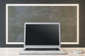Close up of blank black laptop and mouse on chalkboard background, Education, seminar, workshop and mockup concept.
