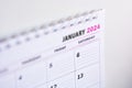 Close up of blank 2024 calendar hanging on fridge with the words January 2024. New year concept, planning and organization. Soft
