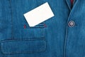 Close-up of a blank card sticking out of a jeans jacket pocket. Royalty Free Stock Photo