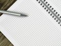 Close up of blank notebook and a pen on wooden office desk with copy space Royalty Free Stock Photo