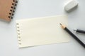 Close up. Blank Paper Sheet with Pencil, Eraser and Spiral Notebook on white Background. Empty Space for Your Text Royalty Free Stock Photo