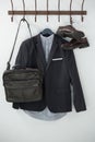 Close-up of blazer, shoes, and bag hanging on hook