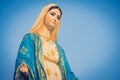 Close-up of the blessed Virgin Mary statue figure. Catholic praying for our lady - The Virgin Mary. Blue sky copy space on Royalty Free Stock Photo