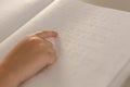 Blind boy hand reading a braille book in classroom Royalty Free Stock Photo