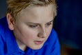 Close up of blond boy in blue shirt