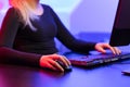 Close-up of Blonde Gamer Girl Playing Online Video Game on Her Personal Computer. Royalty Free Stock Photo