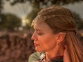 Close-up of blonde girl with blue eyes and elf ears wearing a green cape Royalty Free Stock Photo