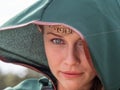 Close-up of blonde girl with blue eyes and elf ears wearing a green cape Royalty Free Stock Photo