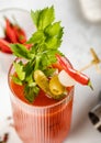 Close up bloody mary cocktail with celery,pickle,olive and red pepper on light background Royalty Free Stock Photo