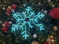 Close up of a blue artificial snowflake and Christmas balls of various colors, both gold and silver and red, hang on the branches. Royalty Free Stock Photo