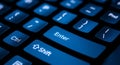 Close-up of a Blue Backlit Keyboard with Focus on Enter and Shift Keys computer technology Royalty Free Stock Photo