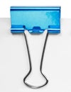 Close up of a blue binder clip Royalty Free Stock Photo