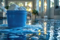 Close-up of a blue bucket and white towels on a freshly mopped floor.