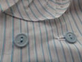 Close up of blue Buttons on a stripped blouse