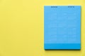 Close up of blue calendar on the yellow background