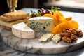 close-up of blue cheese, brie, and cheddar on a marble plate