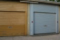 A close up of a blue closed garage door in a parking area