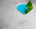Close-up of blue cocktail in martini glass with ice cubes and mint Royalty Free Stock Photo