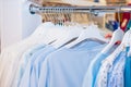 Close up Blue color Clothes on hangers in shop, butique. Make Outfit set. Shopping Mall. Shopper. Sales. Shopping Center. Selectiv