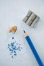 Close-up of blue color pencil with pencil shaving and sharpener Royalty Free Stock Photo
