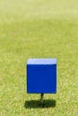 Close-up blue color wooden tee off area or tee box with blurred Royalty Free Stock Photo