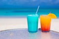Close up Blue Curacao and Mango cocktail on the white sandy beach Royalty Free Stock Photo