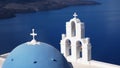 Close up of a blue dome and three church bells in fira on the island of santorini