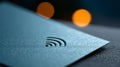 A close up of a blue envelope with an RFID chip in it, and out-of-focus orange circles on the background Royalty Free Stock Photo
