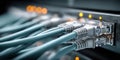 Close-up of blue ethernet cables plugged into a network switch with blinking lights Royalty Free Stock Photo
