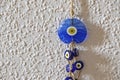 Blue evil eye beads on the wall Royalty Free Stock Photo