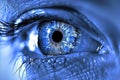 Close up of a blue eye with digital elements, symbolizing the fusion of technology and organic forms in a high tech setting