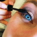 Close up of a blue eye make up mascara rimmel in a beauty center