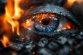 A close-up of a blue eye set against a backdrop of fire and dark charcoal. The flames Royalty Free Stock Photo
