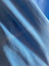 Close up of blue fabric texture with soft folds and light gradients Royalty Free Stock Photo