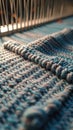 Close-up of blue fabric weaving on loom with sunlight Royalty Free Stock Photo