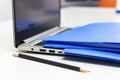 Close Up Blue file folder and Laptop Computer on desk in meeting room, business concept Royalty Free Stock Photo