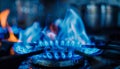 Close-up of a blue fire on a home kitchen stove. Gas stove with burning propane flame Royalty Free Stock Photo