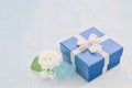 Blue gift box with silver ribbon bow and Jasmine flower Royalty Free Stock Photo