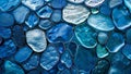 A close-up of blue glass pebbles, each with unique patterns and textures, arranged in an abstract pattern on the wall Royalty Free Stock Photo