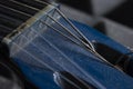 Close-up of blue guitar headstock with a lot of dust and damaged strings Royalty Free Stock Photo