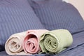 Close up of Blue inn linens and bath towel lying on bed. Hotel service and clean bedroom background. House room and home textile. Royalty Free Stock Photo