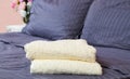 Close up of Blue inn linens and bath towel lying on bed. Hotel service and clean bedroom background. House room and home textile. Royalty Free Stock Photo